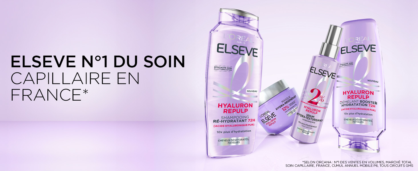 Le texte se lit comme suit : « ELSEVE N°1 DU SOIN CAPILLAIRE EN ». Flacons de produits de beauté teintés de violet disposés en présentoir promotionnel.