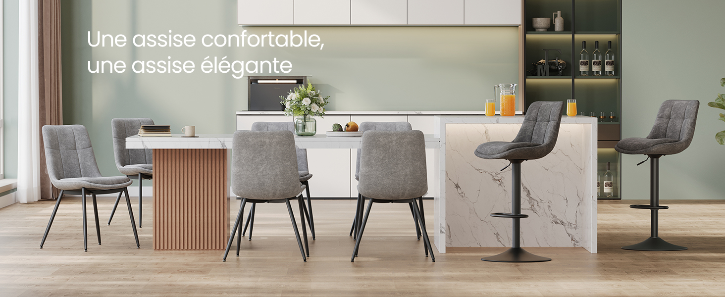 L'intérieur de la salle à manger moderne comprend des chaises rembourrées grises autour d'une table, avec un design minimaliste épuré et un éclairage naturel provenant des fenêtres.