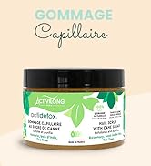avec motif de feuille verte et couvercle noir, étiqueté « Gommage capillaire » (gommage capillaire) dans un emballage français