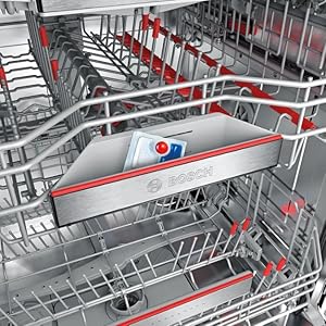 Vue intérieure d'un panier de lave-vaisselle vide avec des flèches rouges indiquant les caractéristiques spécifiques ou les directions de déplacement des composants.