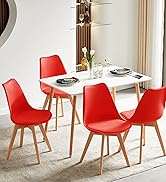 avec table rectangulaire blanche et quatre chaises modernes rouges avec pieds en bois dans un décor intérieur lumineux et contemporain.